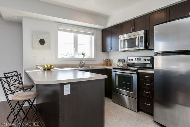 Spacious Kitchen with Stainless Steel and Convenient Breakfast Bar | Image 8