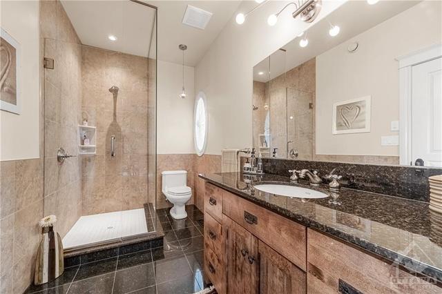 Main Bathroom with Glass Shower, and a beautiful vanity with tons of Storage and Granite Counters | Image 18