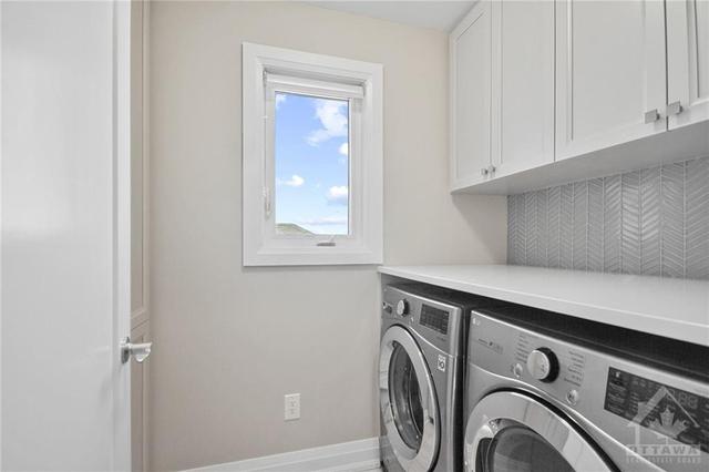 Second floor laundry with custom cabinets and backsplash | Image 22