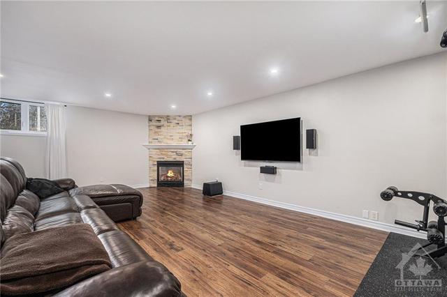 Basement rec room with 2nd nat gas fireplace, new engineered hardwood, removed popcorn ceiling in 2017 | Image 22