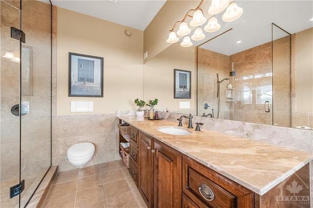 Large En-Suite Bathroom with wall Toilet, large Mirror and Granite Counter with tons of Space and Storage | Image 16