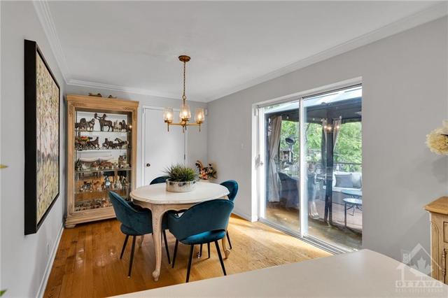 This dining room offers direct access to the back deck as well as direct access to the garage. | Image 10