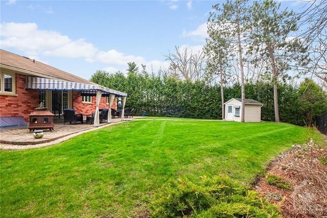 Fenced yard with some hedging and backing onto treed lots. | Image 28
