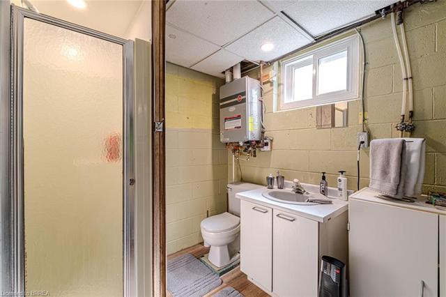 2nd bathroom located just past the laundry room. *Note the on demanded rented water heater | Image 24