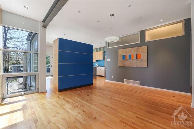 Another view out towards the kitchen and eating area showing the vistas out to the gardens and the natural light. Transoms add natural light to the laundry room and powder room. Maple floors and r | Image 13