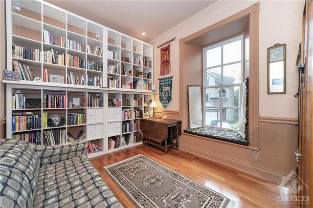 Main floor bedroom or Den with window seat and wall of library shelves. | Image 13