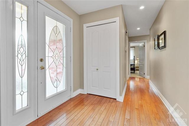 Foyer to hallway leading to bedrooms and garage access | Image 11