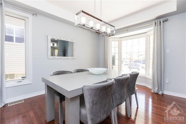 The main level welcomes you with a formal dining room flooded with sunshine through the bay window. | Image 3