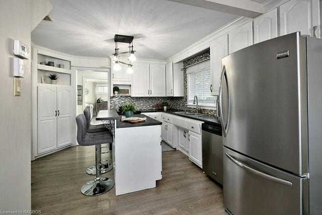 view of kitchen from dining room | Image 5