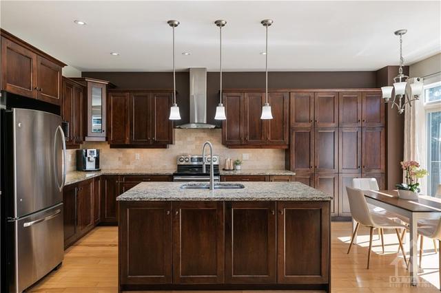 Kitchen with granite counters, tumbled stone backsplash & ample cabinetry | Image 8