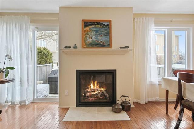 Featuring a charming natural gas fireplace (installed in 2018) that adds warmth and ambiance | Image 8
