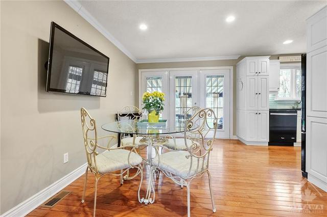 Dining/Den off kitchen with patio doors leading to covered porch and landscaped large back yard. | Image 4