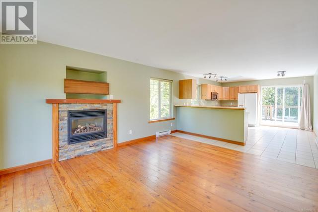 upper living room with wood floors and propane fireplace | Image 3