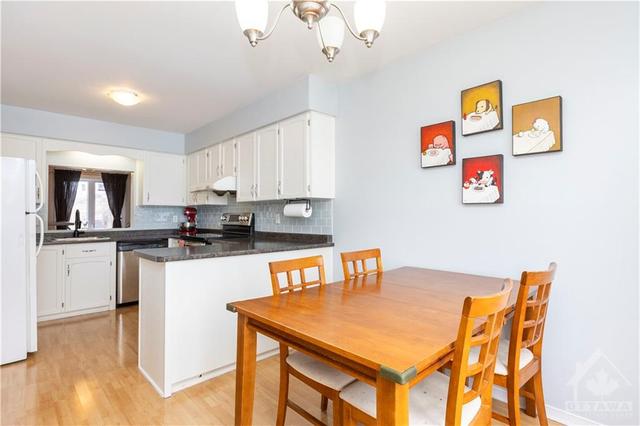 Spacious sunlit kitchen and eating area. | Image 6