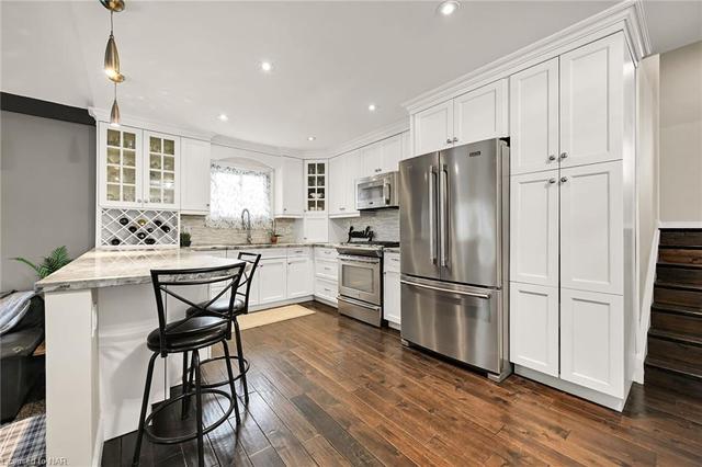 Renovated kitchen with tons of cupboards and wine rack | Image 32