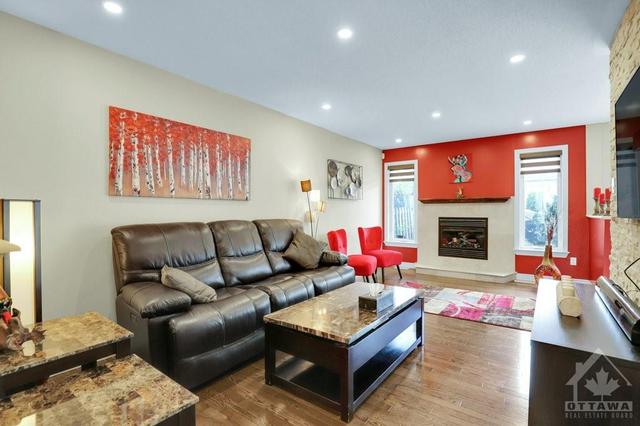 Great Room with gas fireplace featuring stone wall for your mounted TV | Image 14