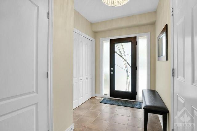 Wide & Bright tiled sunken Foyer with new Front Door & Double Closet | Image 3