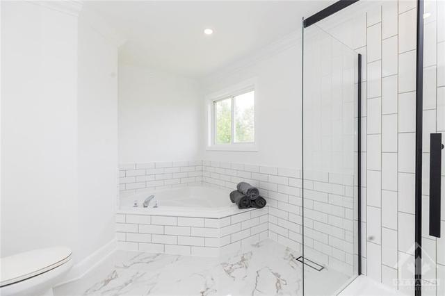 Luxurious soaker tub and large glass shower | Image 10