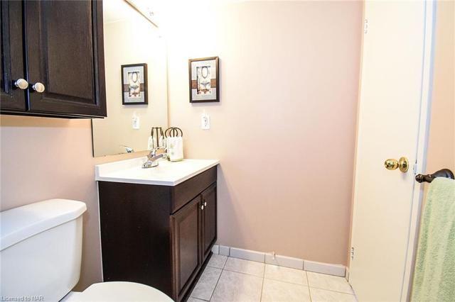 In the Primary room, there is a full-size washer and dryer with triple closets across. There is a 3-piece en-suite located at the end of this hallway. | Image 21