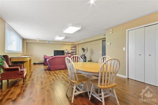 Beautiful common/party room on first floor offers a kitchenette, elliptical, TV, library & shuffleboard. Let the fun begin! | Image 25