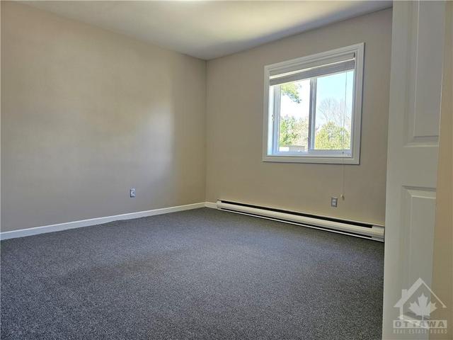 Bright and spacious primary bedroom with front views of the courtyard and parking lot! | Image 16