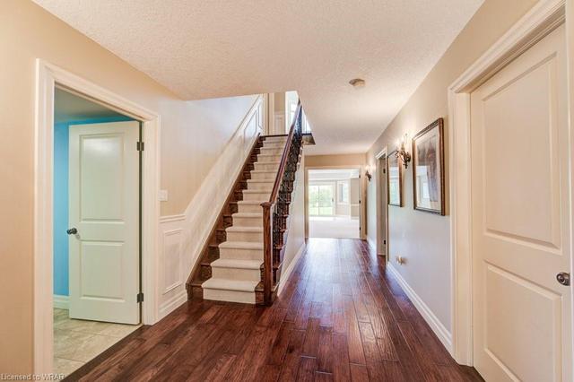 Situated at the back of the house, this handsome primary suite offers a double door entry, hickory hardwood flooring, a spacious walk in closet and views of the golf course. | Image 16