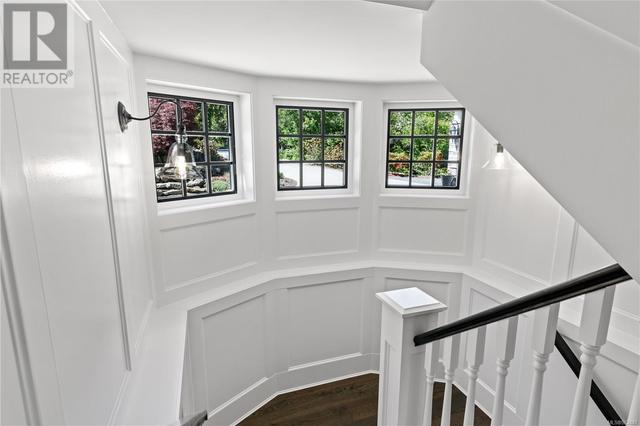 Quality millwork on the staircase heading to the lower floor | Image 49