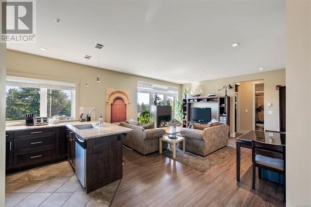 9 ft ceilings, laminate flooring, and space for seating at the kitchen counter next to the living room | Image 7