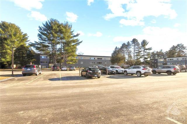 Recently resurfaced parking lot offers exclusive use parking spots w/ electric receptacles and convenient visitor parking! | Image 28