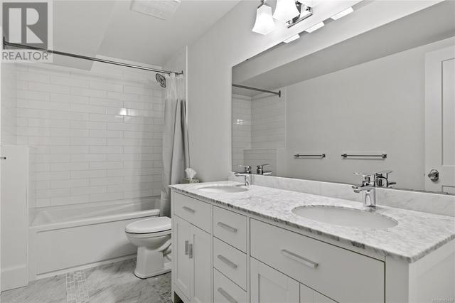 Suite bathroom with quartz twin sink vanity and marble floors | Image 61