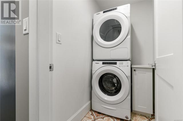 Separate laundry complete with hand painted tile floors | Image 62