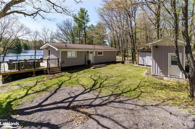 Welcome to 26 Loon Lake Road with a renovated cottage over looking crystal clear Loon Lake , a spacious deck, a bunkie, a shed, and a detached garage. | Image 1