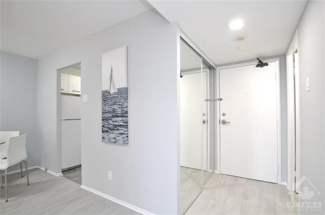 Inviting entrance with mirrored closet doors | Image 8
