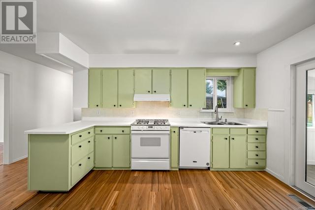 Kitchen With fresh Paint and new laminate flooring. | Image 4
