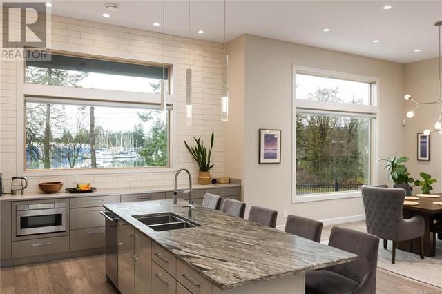 High ceilings and open concept in this sun drenched kitchen/dining area | Image 12
