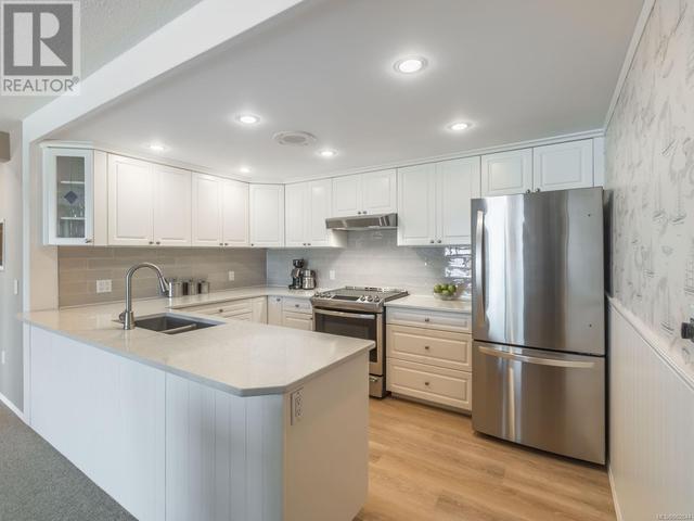 Chef's dream kitchen equipped with high-end stainless steel appliances, Quartz countertops, and ample cabinet space to prepare delicious meals while gazing out at the ocean.... | Image 9