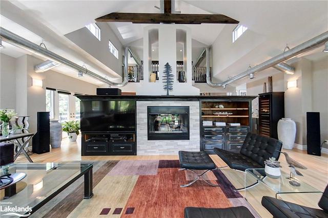 Living Room with a Vaulted Ceiling and the Double-Sided Fireplace | Image 5