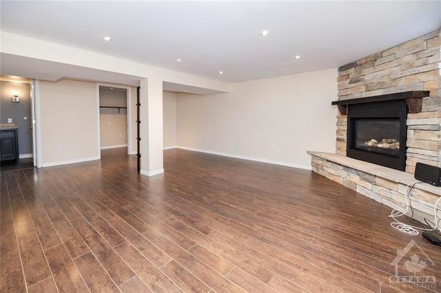 Finished basement family room with gas fireplace | Image 18