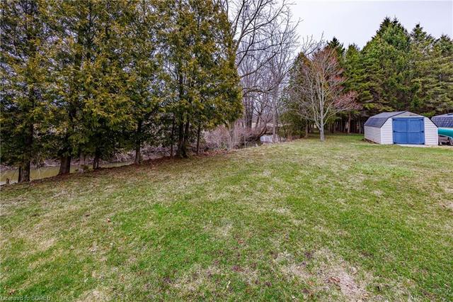 Side Yard showing wooded area and shed | Image 15