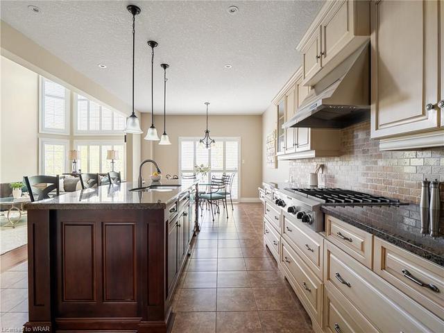 Take part in the prep of your favorite meal around the island with your significant other and enjoy the space and functionality of this well laid out Kitchen. | Image 38