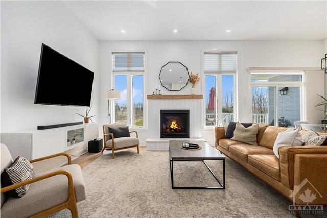 What an awesome sun filled living room! There is nothing like having all of those windows to appreciate living in the country and especially with the fireplace right there for the snowy days. | Image 4