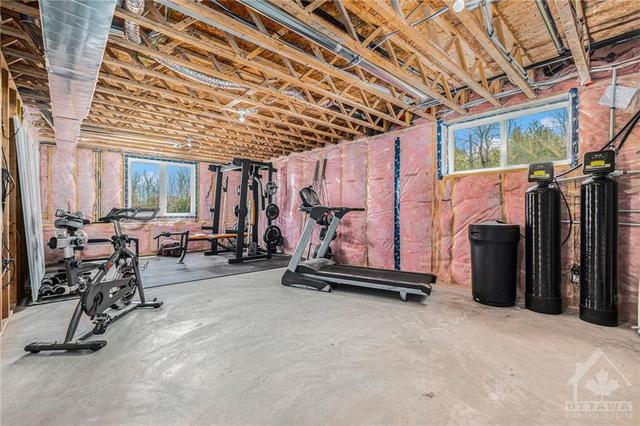There is a lot of un developed space in this lower level. This is great for the gym but could also be a heck of a work shop with the door way up to the garage. It could also make a great granny suite. | Image 20
