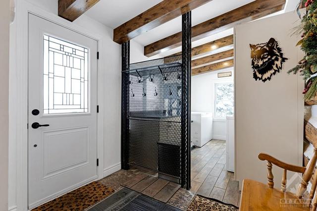 Inviting foyer porcelain floor that extends into attached laundry room | Image 10
