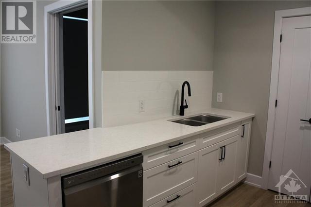 Bright, modern style with quartz countertops and stainless steel appliances (from unit with reverse floor plan) | Image 21