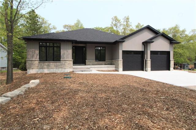Front of home with a concrete pad infront of the double garage | Image 1