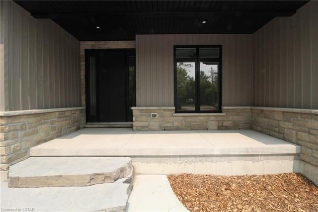 Spacious covered front porch showing stone banding and Hardy Board siding | Image 45