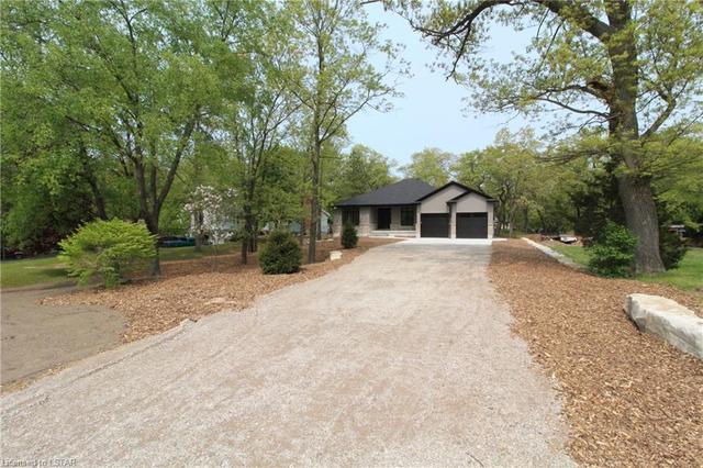 Home is surrounded by mature trees and has a gravel lane up to the house | Image 23