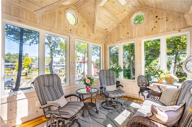 Cozy sunroom wihere you can watch the boats go by and the sun set! | Image 35