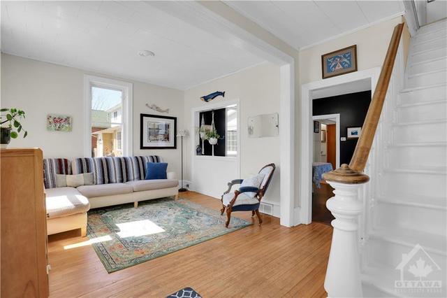 As we walk into the home we are greeted by a century-old staircase and grand open space. | Image 4