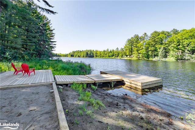 A fabulous waterfront with the quintessential lakeside firepit and brand new dock. | Image 36